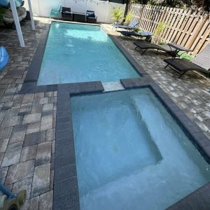 inground pool and spa being cleaned