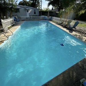 inground pool being cleaned