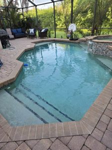inground pool being cleaned