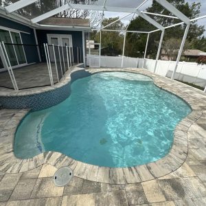 inground pool being cleaned
