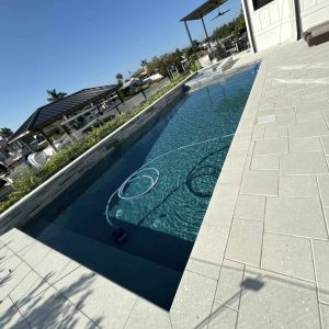 inground pool being cleaned