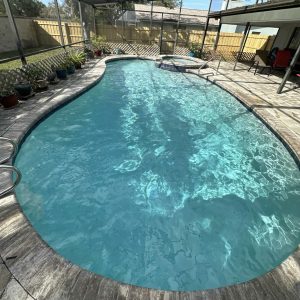 inground pool being cleaned