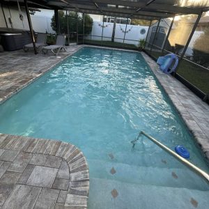 inground pool being cleaned