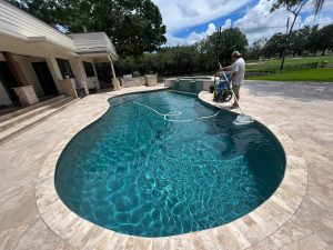 inground pool being cleaned