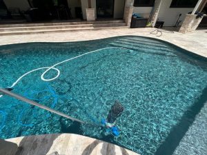 inground pool being cleaned
