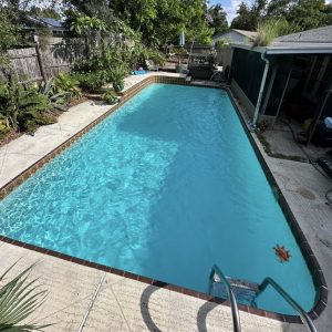 inground pool with clear blue water after being cleaned